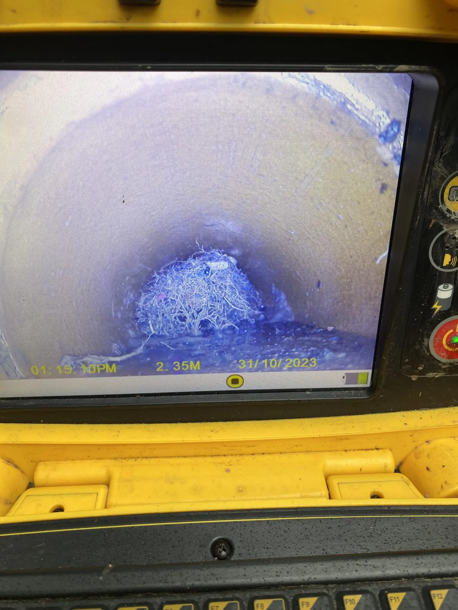 CCTV drain camera view showing a blockage inside a pipe